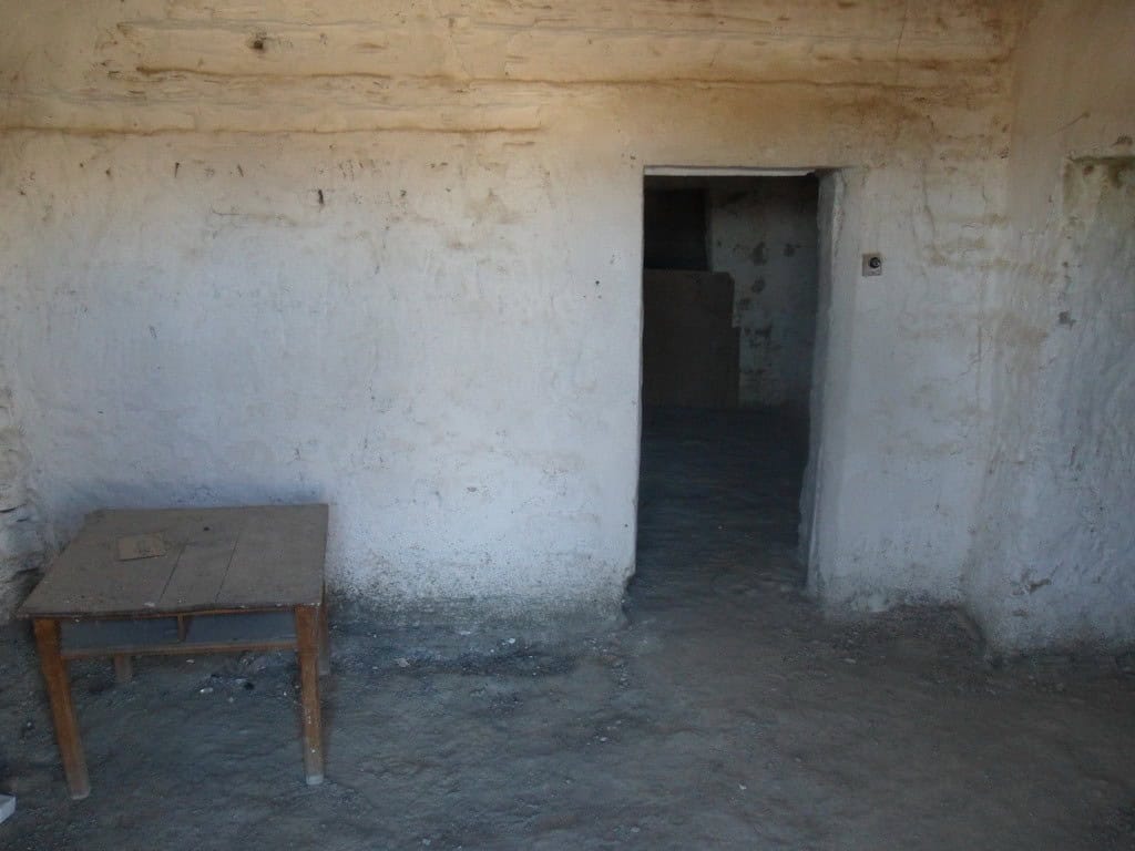 Cave house interior with rustic walls and doorway in Benamaurel, Granada. Ideal for renovation or un.