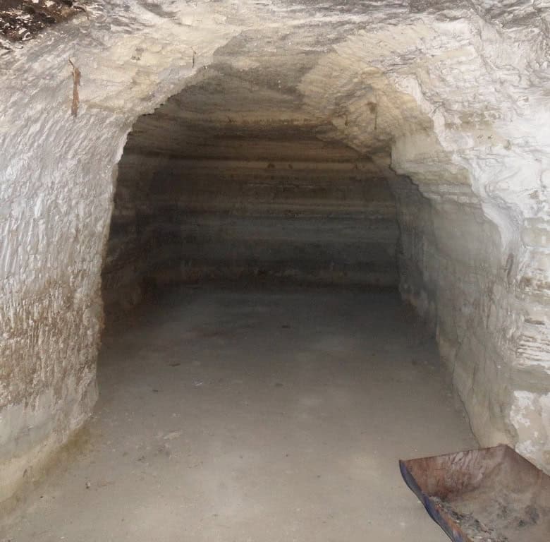 Cave house interior in Benamaurel, Granada, showcasing traditional rock architecture.