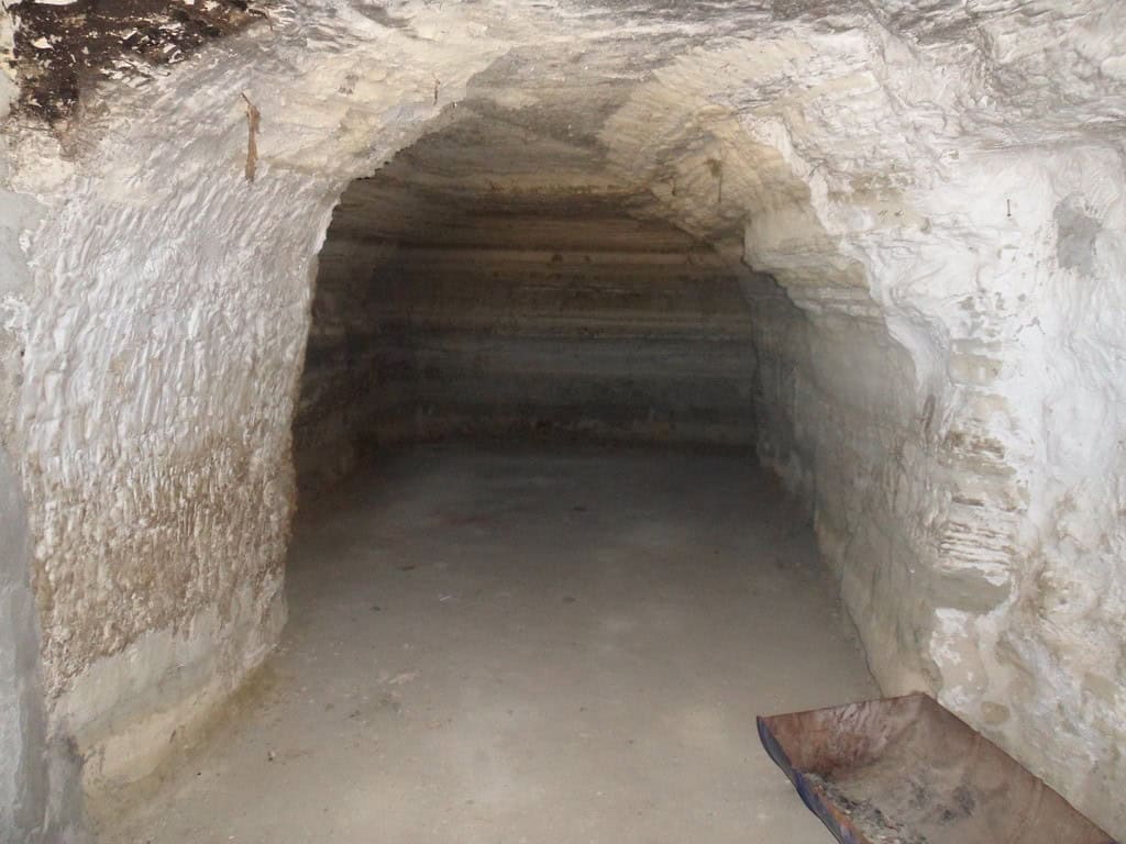 Cave house interior in Benamaurel, Granada, showcasing traditional rock architecture.