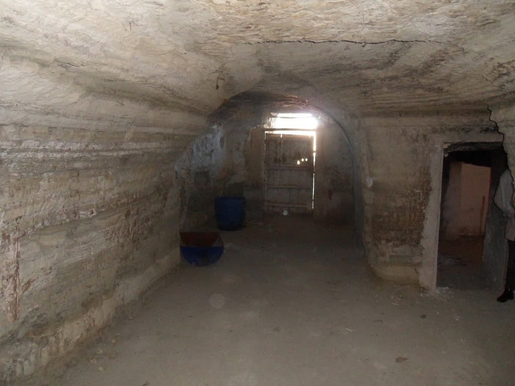 Cave house interior in Benamaurel, Granada, showcasing natural rock walls and rustic charm.