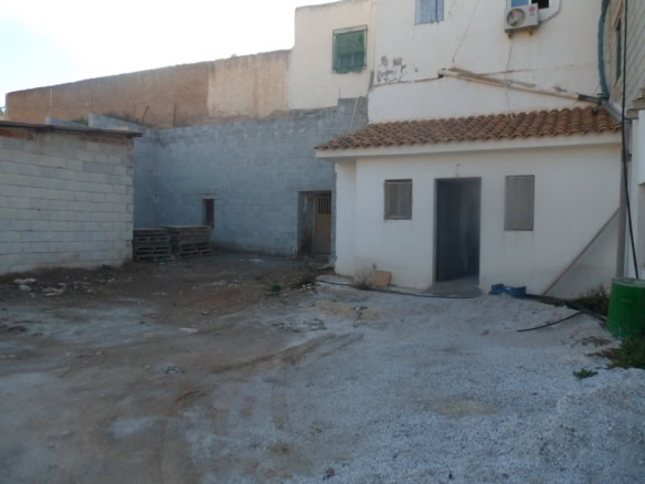 Cave house in Freila, Granada, with traditional white exterior and surrounding outdoor space.