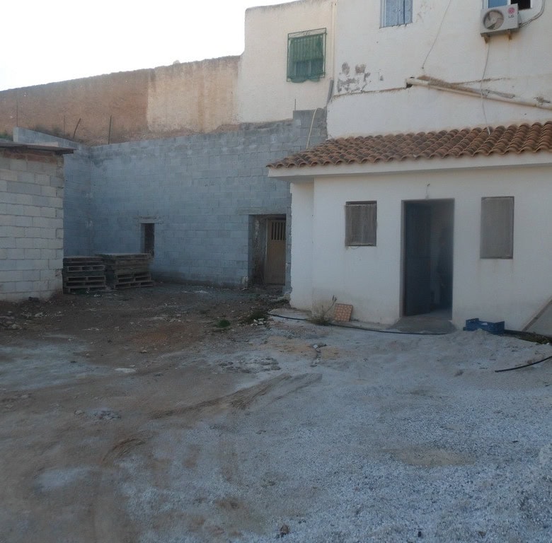 Cave house in Freila, Granada, with traditional white exterior and surrounding outdoor space.