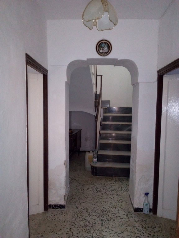 Charming entrance of a town house in Tijola, Almeria, featuring a staircase and traditional interior.