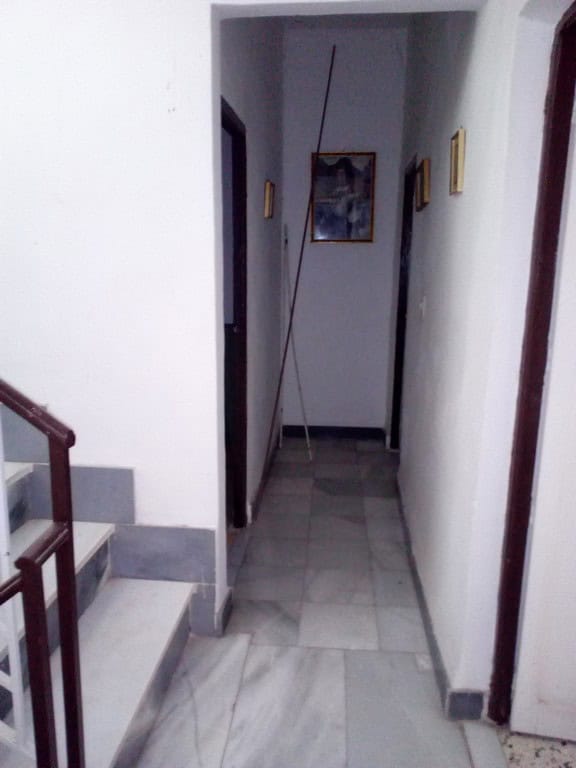 Interior corridor of a town house in Tijola, Almeria, showcasing simple decor and clean white walls.