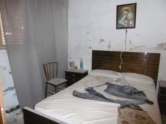 Charming bedroom in Tijola town house with simple decor and a comfortable bed.