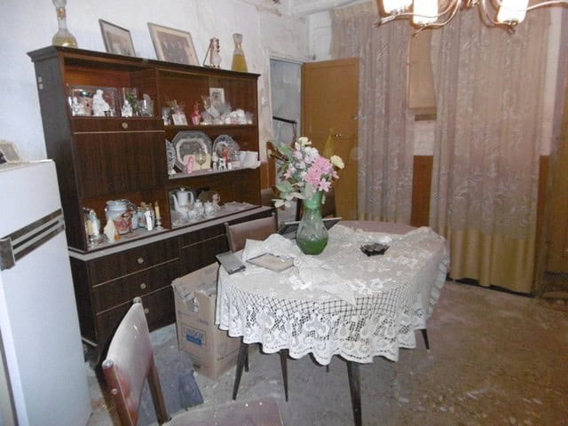 Charming interior of a town house in Tijola, Almeria, featuring a dining area with a lace tablecloth.