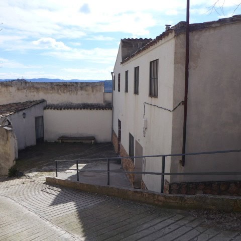 Rural property in Don Pedro, Jaen, featuring traditional whitewashed buildings and scenic mountain v.