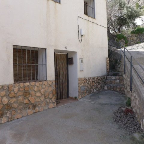 Charming rural property entrance in Don Pedro, Jaen with stone accents and outdoor stairs.