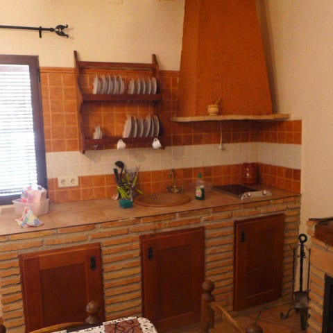 Rural property kitchen in Don Pedro, Jaen featuring traditional terracotta tiles, wooden cabinets, a.