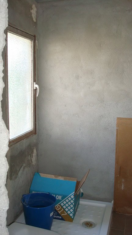 Interior view of an unfinished rural property in Cela, Almeria, with a window, concrete walls, and c.