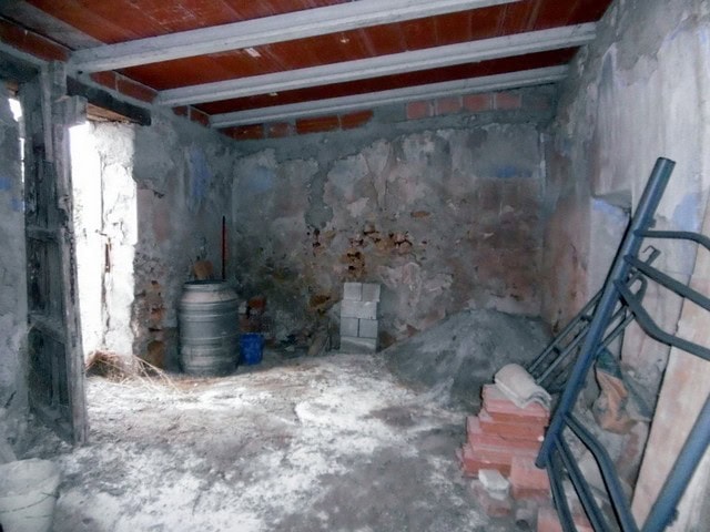 Rural property under renovation in Hijate, Almeria, with exposed brick walls and construction materi.