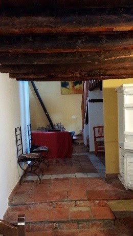 Interior view of a traditional town house in Quesada, Jaen, showcasing rustic wooden ceiling and coz.