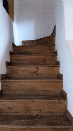 Wooden staircase inside a town house in Quesada, Jaen, showcasing rustic charm and traditional desig.