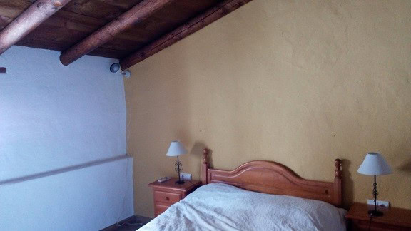 Elegant bedroom with wooden furniture in a traditional town house in Quesada, Jaen. Perfect for comf.