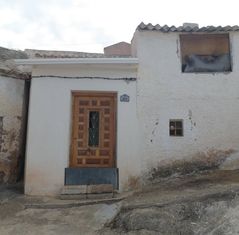Cave house in Freila, Granada, featuring rustic architecture and unique hillside location.