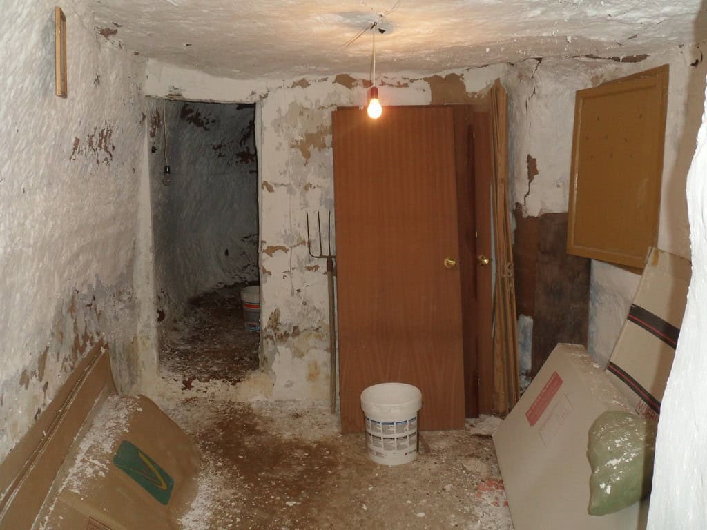 Cave house interior with rustic walls and basic fixtures in Freila, Granada. Ideal for renovation or.