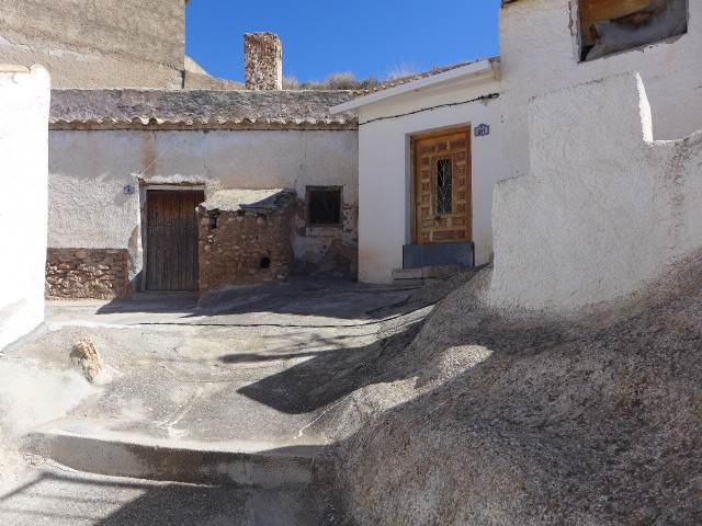 Authentic cave house in Freila, Granada with rustic exterior and unique architecture.