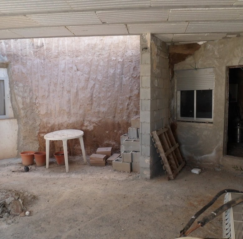 Traditional cave house in Freila, Granada with rustic interior and outdoor space.