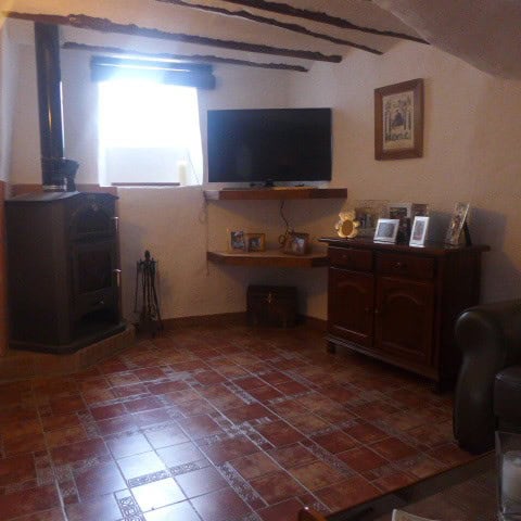Traditional cave house living room with rustic decor in Galera, Granada.