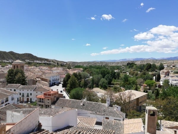 Cave house in Galera, Granada, surrounded by lush greenery and scenic views.