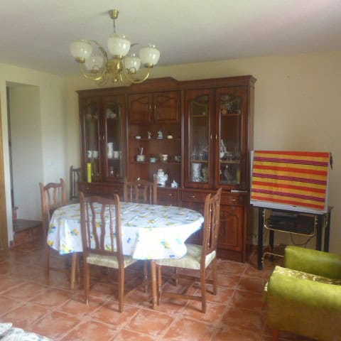 Interior view of a town house in Castril, Granada with dining area and vintage furniture.