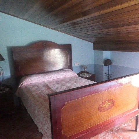 Cozy bedroom in a town house located in Castril, Granada, featuring wooden ceiling and classic furni.