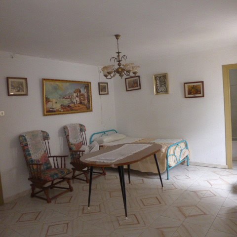 Charming interior of a town house in Castril, Granada, featuring a dining area with vintage chairs a.