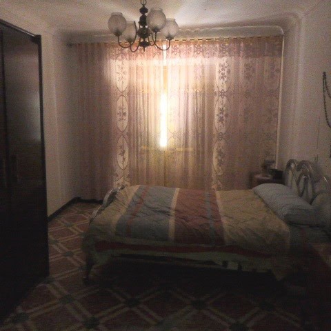 Bright bedroom with large window and sheer curtains in Castril, Granada.