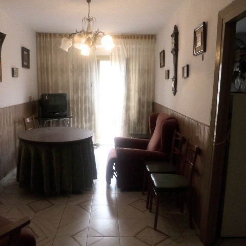 Charming interior of a town house in Castril, Granada, featuring a dining area with a round table, a.