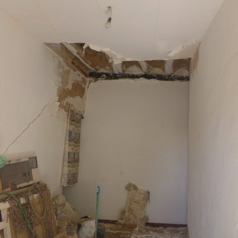 Renovation in progress of a town house in Cullar, Granada, showing damaged walls and ceiling.