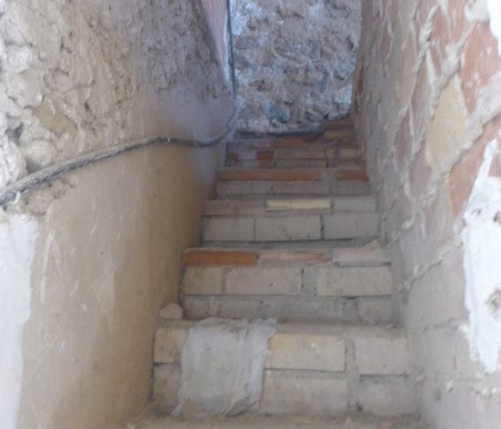 Historic town house staircase in Cullar, Granada, showcasing traditional architecture and rustic cha.