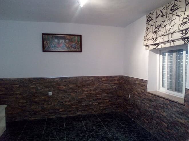 Interior of village property in Tijola, Almeria with simple decor and a window view.
