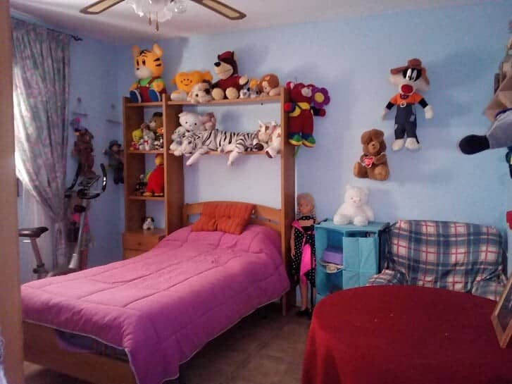 Charming village home in Tijola, Almeria, featuring a colorful bedroom with plush toys and vibrant d.
