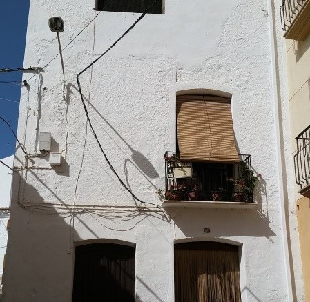 Traditional whitewashed village property in Purchena, Almeria, featuring rustic wooden shutters and.