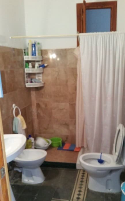 Charming village property bathroom in Purchena, Almeria with basic amenities and traditional decor.
