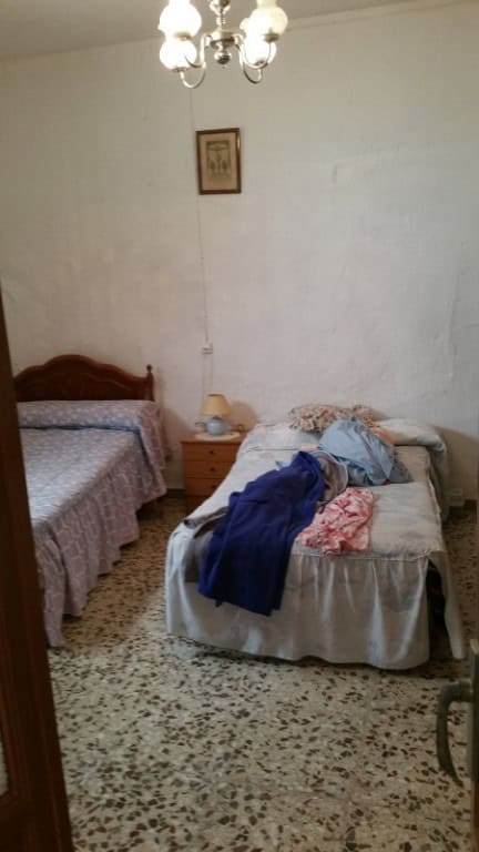 Charming village home interior in Purchena, Almeria, featuring simple furnishings and cozy bedrooms.