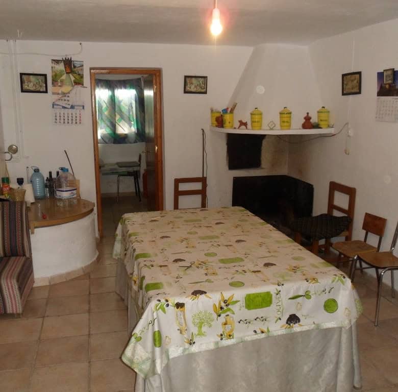 Farm property interior with dining table and chairs in Baza, Granada, Spain.