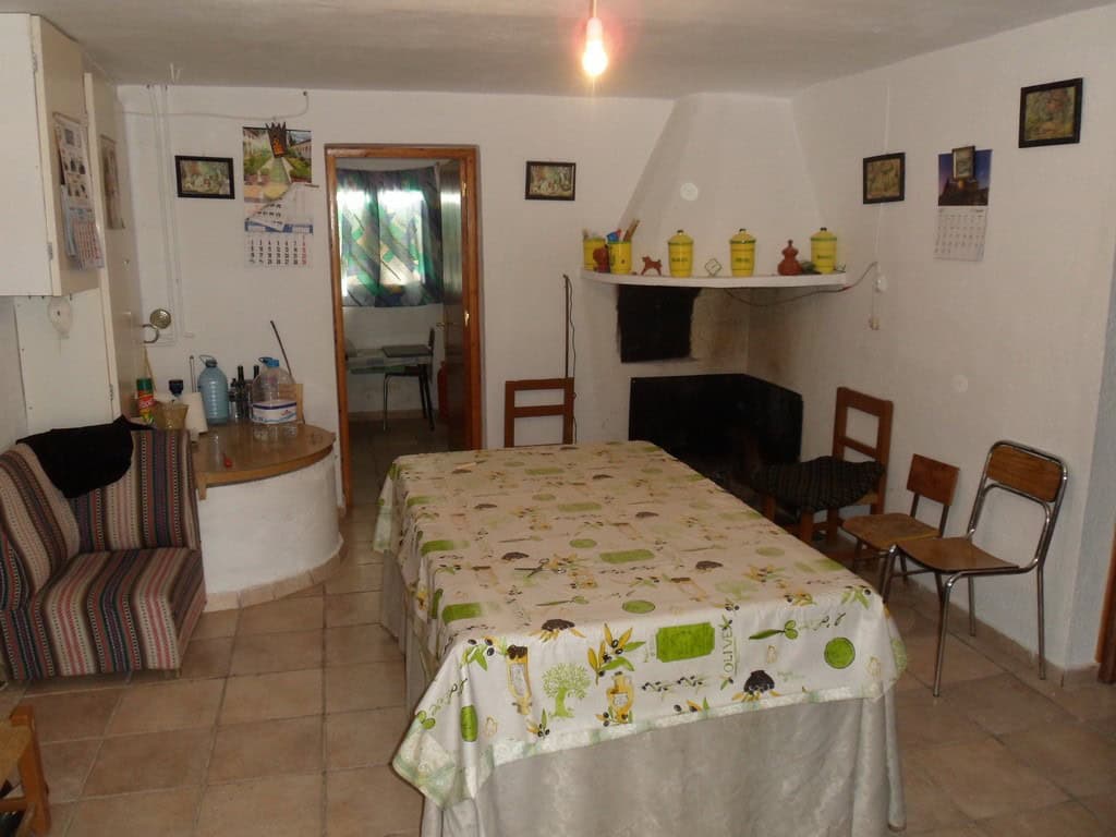 Farm property interior with dining table and chairs in Baza, Granada, Spain.