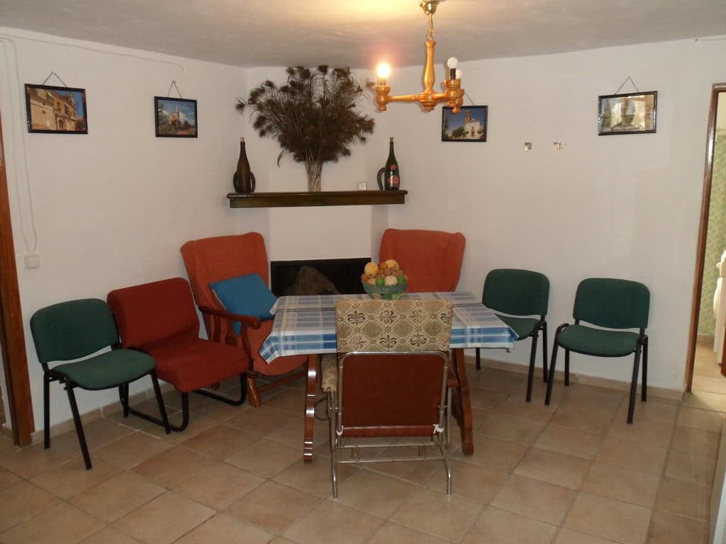 Farm property in Baza, Granada with a cozy dining area and traditional decor. Perfect for rural livi.