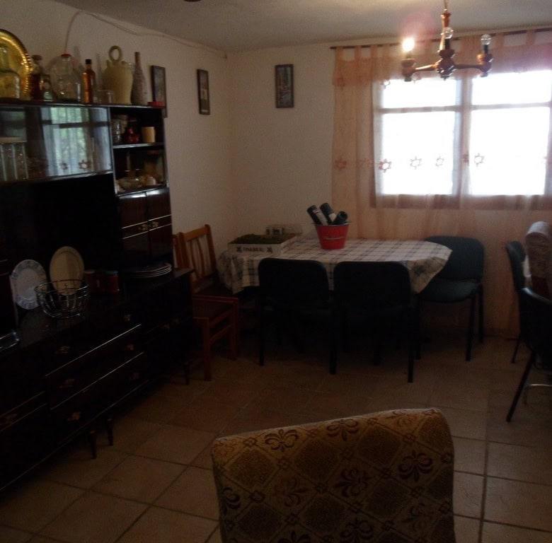 Farmhouse interior in Baza, Granada with traditional decor and spacious dining area.