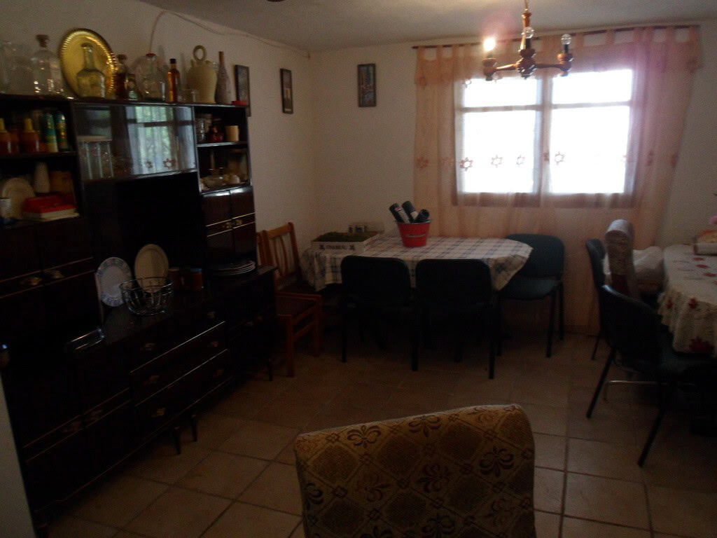 Farmhouse interior in Baza, Granada with traditional decor and spacious dining area.