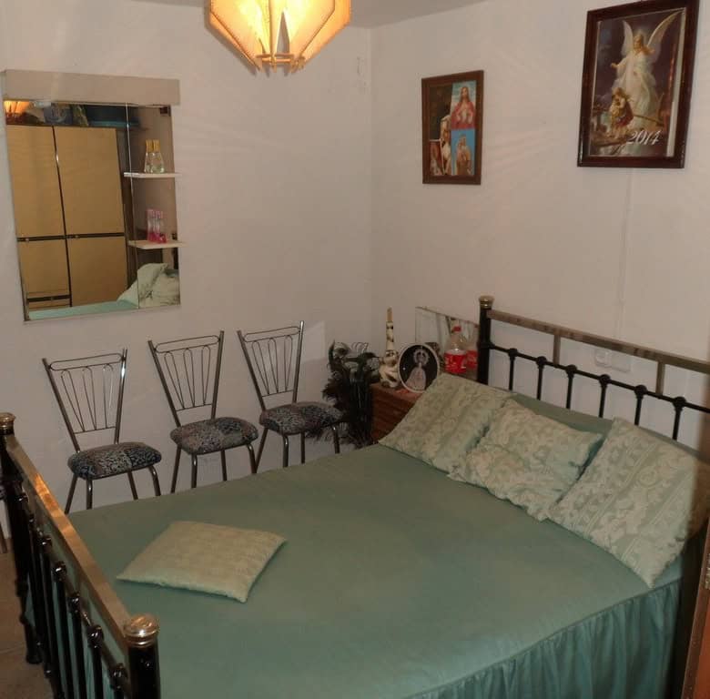 Farm property in Baza, Granada with cozy bedroom and traditional decor. Ideal for rural living or in.