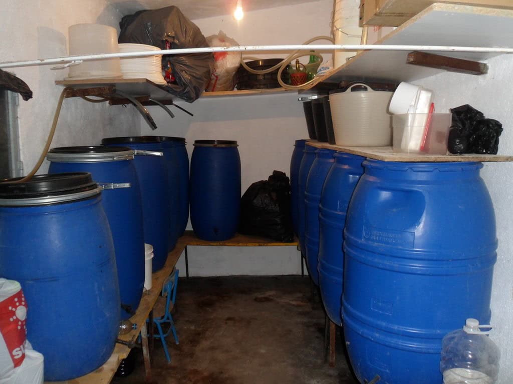 Storage room with blue barrels in a farm property in Baza, Granada.