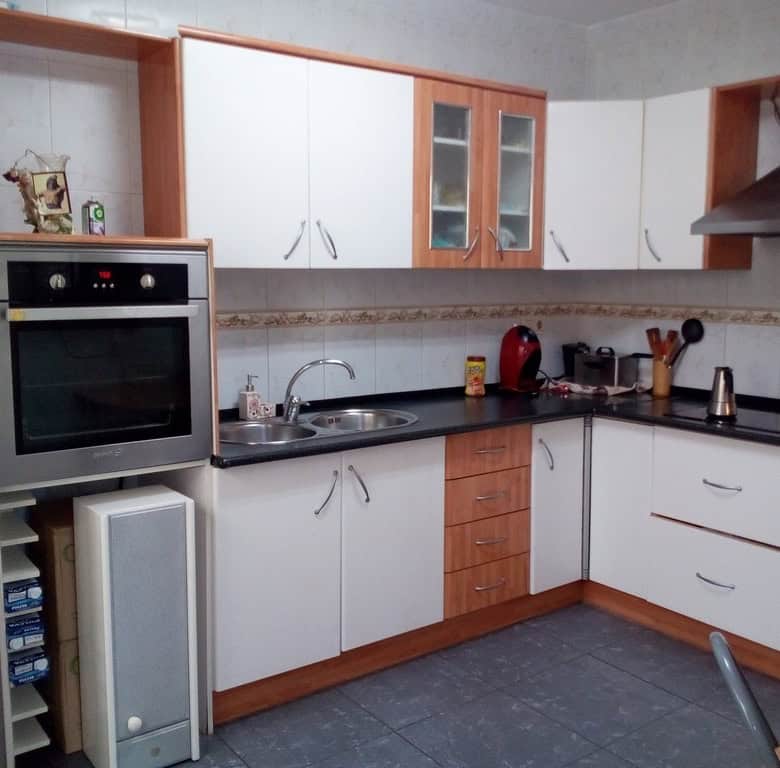 Charming kitchen in a village property in Cela, Almeria, featuring modern appliances and wooden acce.