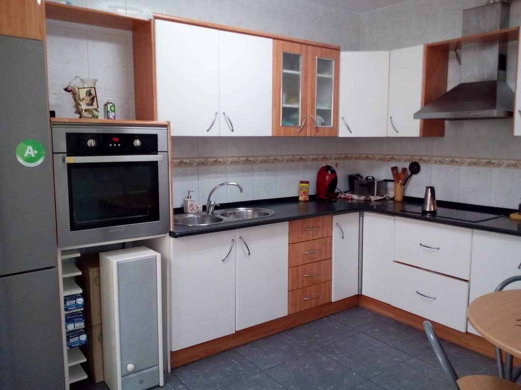 Charming kitchen in a village property in Cela, Almeria, featuring modern appliances and wooden acce.
