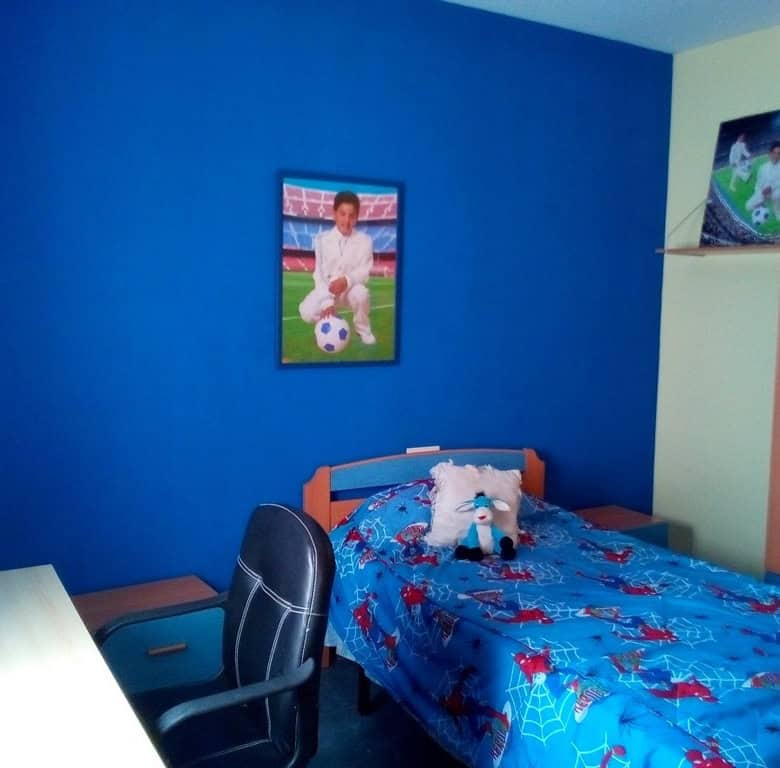 Charming village home in Cela, Almeria, featuring a cozy bedroom with vibrant decor and local artwor.