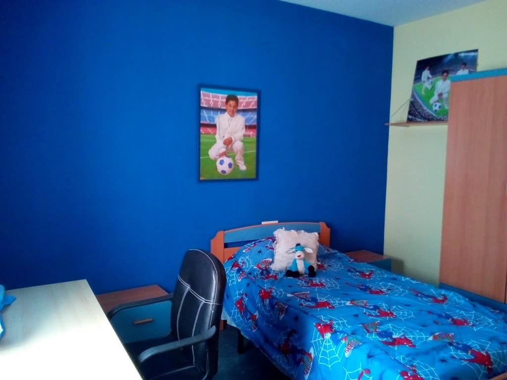 Charming village home in Cela, Almeria, featuring a cozy bedroom with vibrant decor and local artwor.
