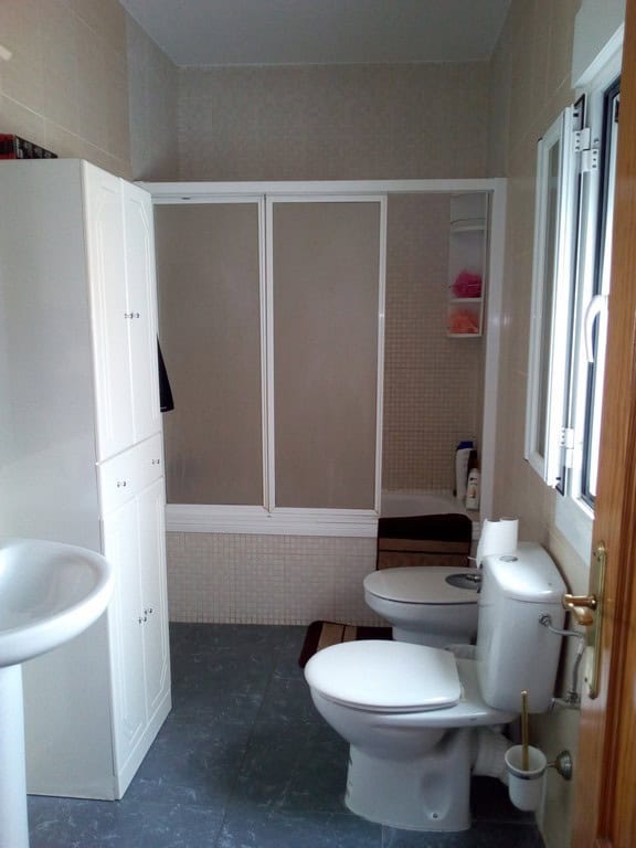 Bright bathroom with shower, toilet, and storage in Cela village, Almeria.