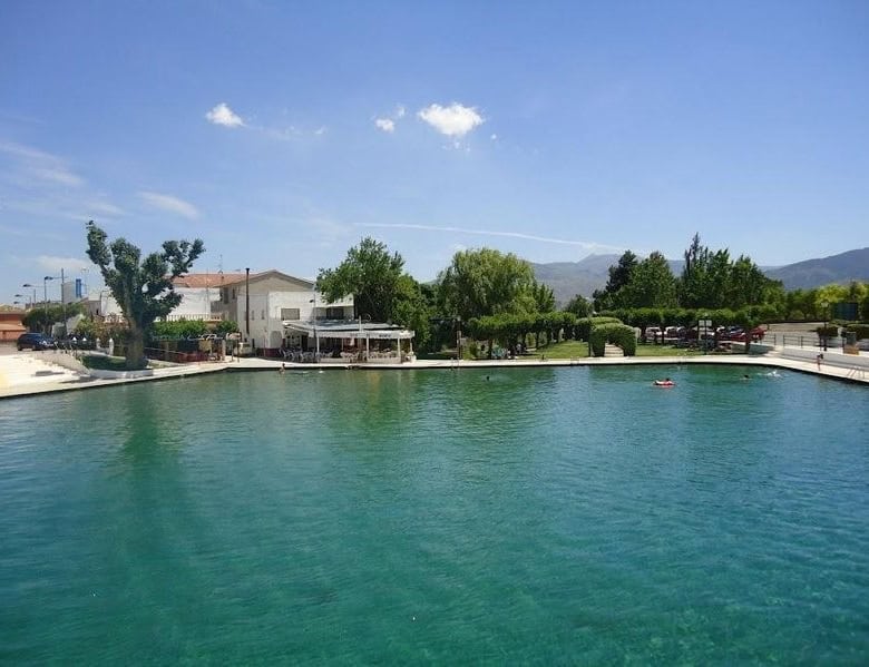 Scenic village property in Cela, Almeria with waterfront views and lush greenery.