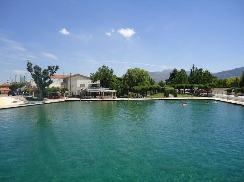 Scenic village property in Cela, Almeria with waterfront views and lush greenery.